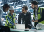 Engineers looking at a digital device 