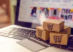 Online shopping - laptop, bank card and small shopping cart