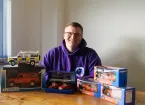 Man smiling with collectables 