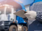  Dump truck driver man in uniform with tablet computer controls loading of cargo