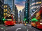 Sunset at the City of London, England, with street traffic light trails and illuminated skyscrapers