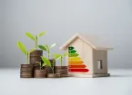 Stacked coins, house with energy efficiency graph 
