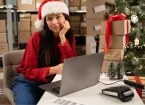 Employer looking at a digital device wearing a Christmas hat 