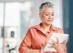 Mature female employee looking at a digital device 