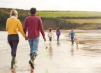 Family walking on a beach 