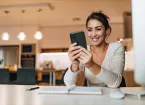 person looking at their mobile phone at work 