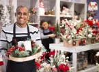 person working in shop selling Christmas goods