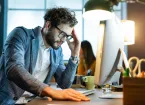 Tired employee looking at a laptop