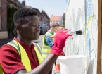 Young volunteer painting in the community 