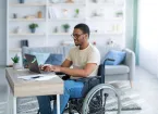 Wheelchair user, working from home using a laptop 