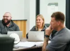 Team smiling and discussing around a table