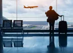 Person at an airport with a suitcase 