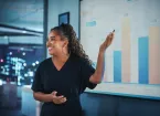 person giving a presentation using graphs