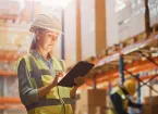 Warehouse worker looing at a digital tablet 