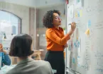 Tech Engineer Pitching Revolutionary Innovative Product. Whiteboard Shows Graphs, Infographics, AI, Big Data, Mind mapping