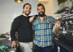 small business owners standing in their cafe 