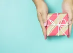 Hands holding craft paper gift box