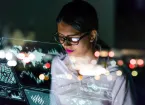 businesswoman looking at futuristic interface screen.