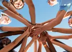 volunteers touching hands 