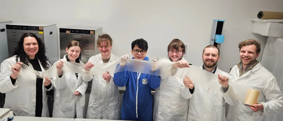 Plantsea staff stand in a line holding up their seaweed based packaging.
